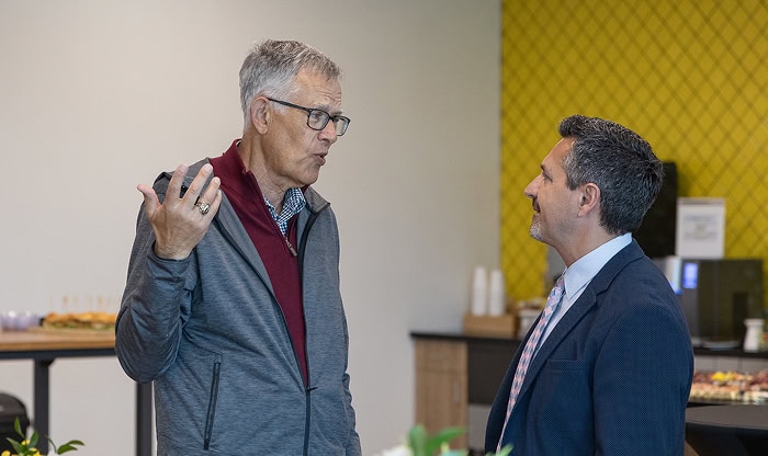 Two professionals engaging in a discussion during a broker partnership event at Vast Coworking, highlighting networking and collaboration opportunities.