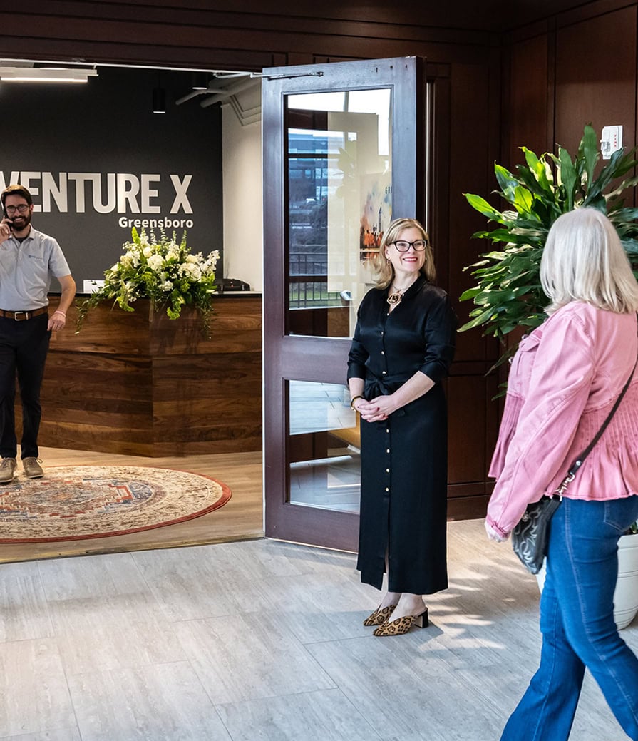 Modern coworking space entrance with professionals engaging, showcasing a collaborative environment at Vast Coworking, aligned with landlord partnership initiatives.