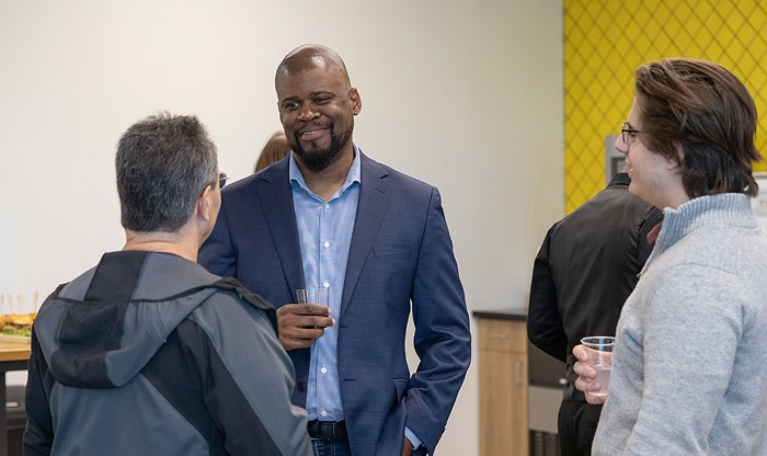 Business professionals networking at Vast Coworking, highlighting landlord partnerships and collaborative workspace environment.