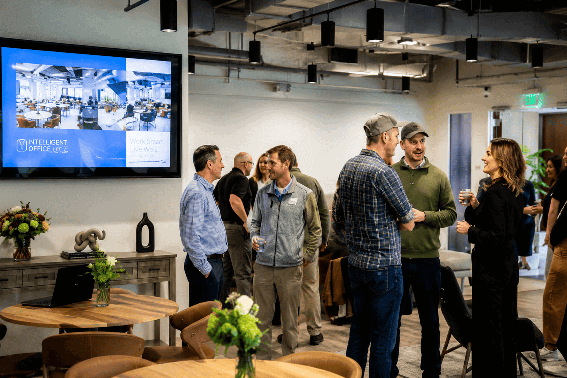 Networking event at Vast Coworking space with professionals engaging in conversations.