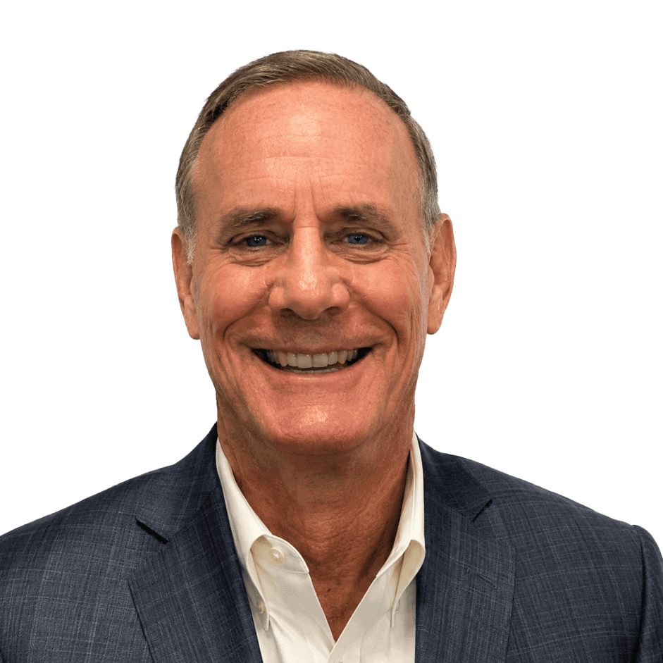 Professional man in a suit smiling, representing a business environment at Vast Coworking.