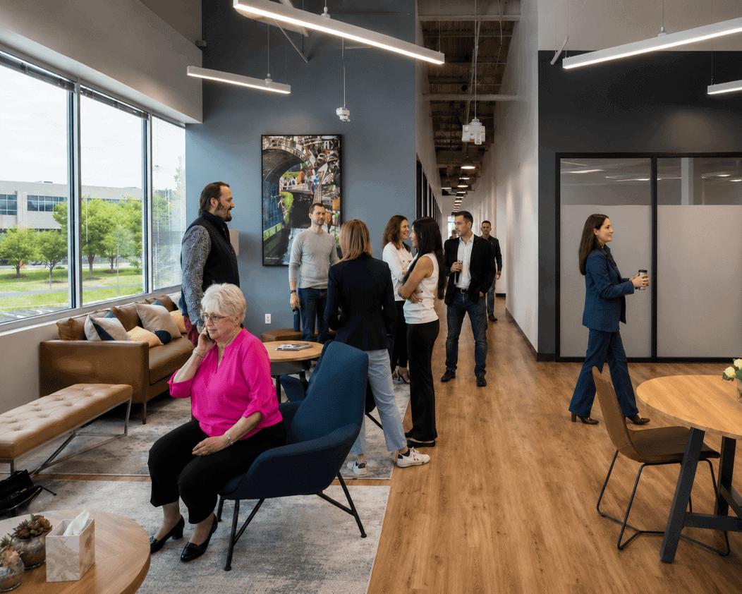 Vast Coworking space with professionals networking and working in a modern, well-lit environment.
