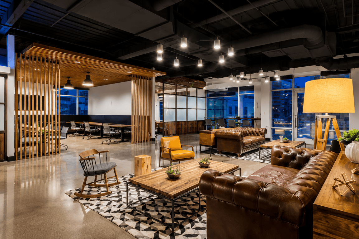 Modern coworking space with comfortable seating, wooden accents, and large windows at Vast Coworking.