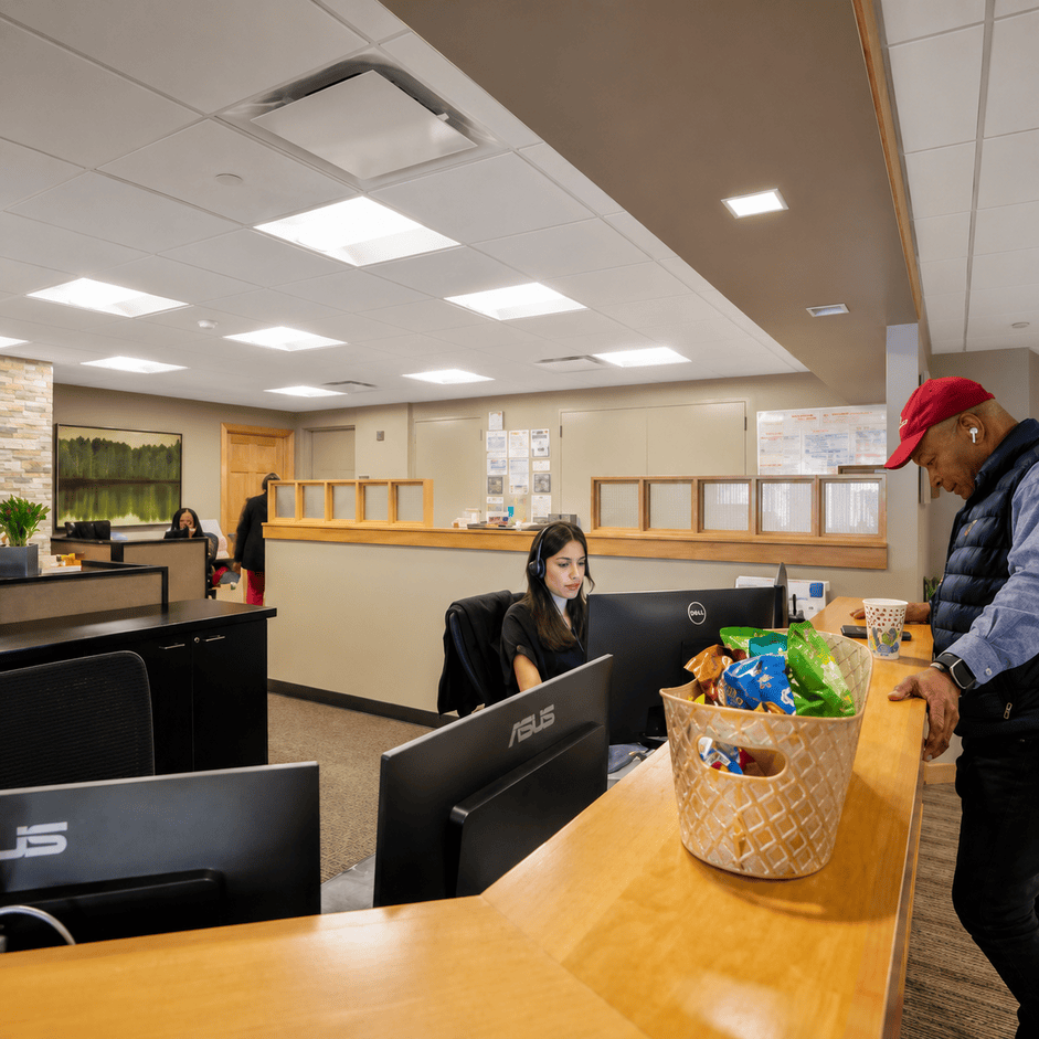 Vast Coworking space with people working at desks, featuring modern decor and a welcoming environment.